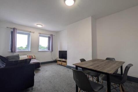 A spacious and inviting modern living room, per...