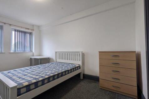 A bright and inviting double bedroom with ample...