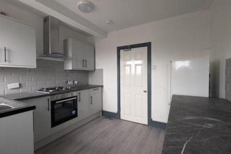 A modern and tidy kitchenette featuring sleek c...