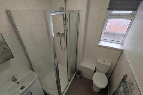 A modern and tidy bathroom featuring a sleek sh...