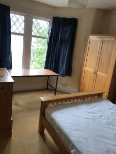 This charming double bedroom features large win...