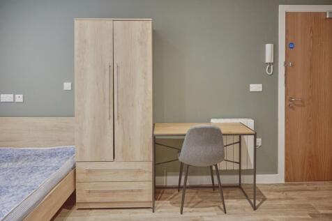 A modern and tidy double bedroom featuring a fi...