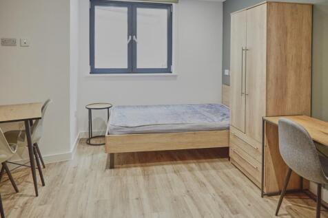 A bright and inviting double bedroom featuring ...