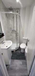 This stylish bathroom features a modern shower ...