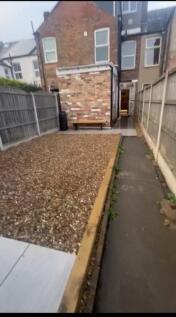 This charming garden space features a well-main...
