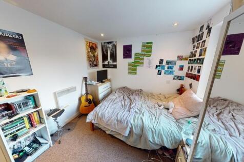 A cozy double bedroom featuring a comfortable d...