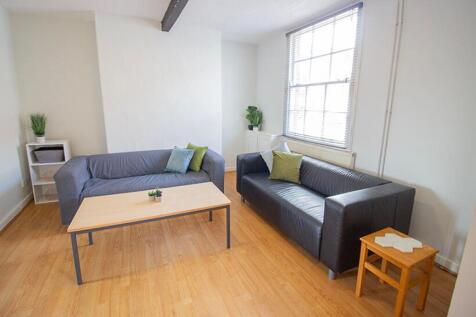 A bright and spacious living room featuring mod...