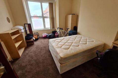 A well-maintained bedroom featuring a comfortab...
