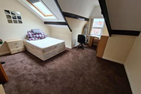 A cozy bedroom with a comfortable double bed, a...