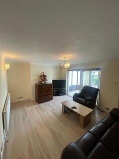 A bright and welcoming living room featuring co...
