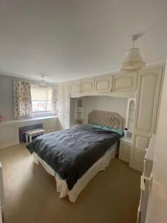 Comfortable double bedroom featuring built-in c...
