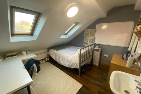 A bright and inviting double bedroom featuring ...