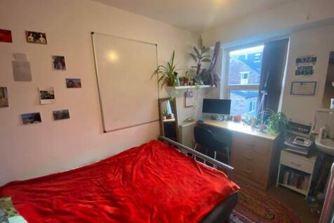 A cozy and well-lit double bedroom featuring a ...