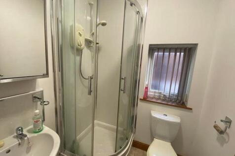 A bright and tidy bathroom featuring a modern s...