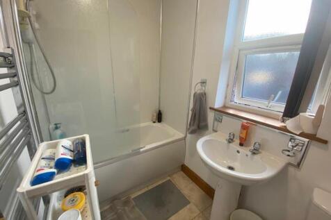A bright and tidy bathroom featuring a modern b...