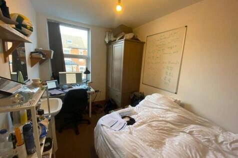A cozy double bedroom featuring ample study spa...