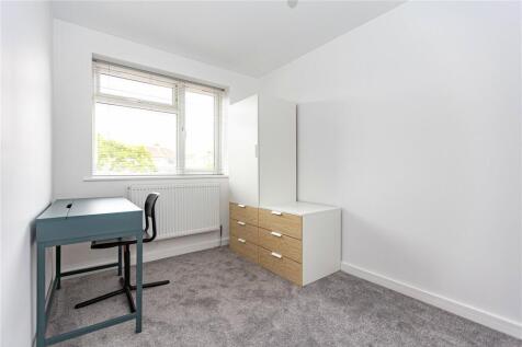A bright and tidy single bedroom featuring a la...
