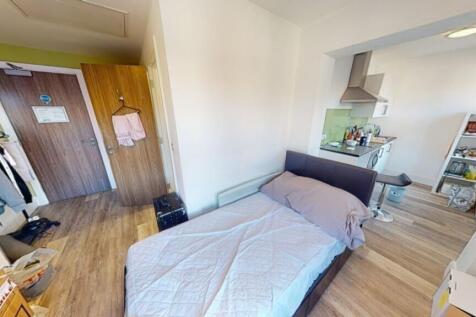 Spacious double bedroom featuring a cozy bed, a...