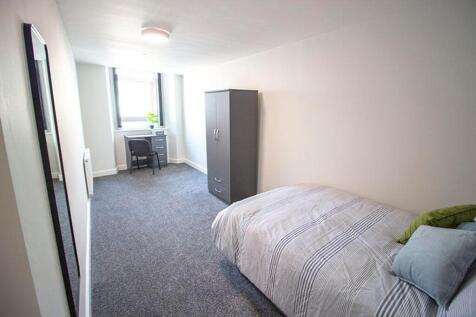 Spacious double bedroom featuring a cozy bed, a...