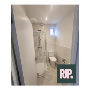 Modern bathroom featuring a sleek shower unit a...