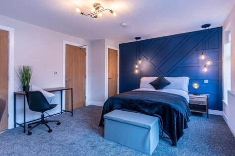 A stylish and modern bedroom featuring a large ...