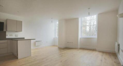Bright and spacious living room with large wind...