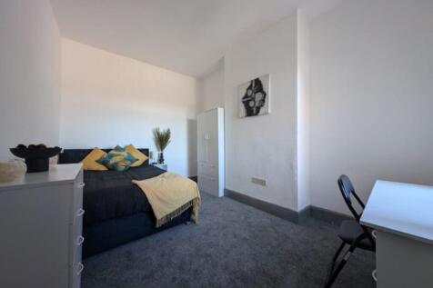 Spacious double bedroom featuring a cozy bed ad...