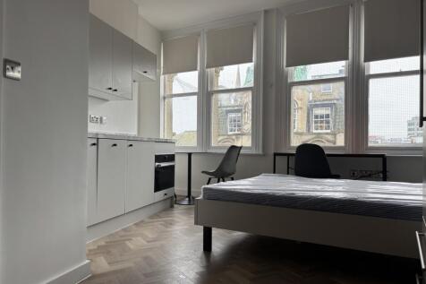 A spacious and bright double bedroom featuring ...