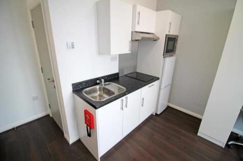 This modern kitchen features sleek cabinetry an...