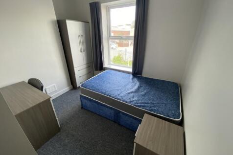 Cozy double bedroom featuring a comfortable bed...
