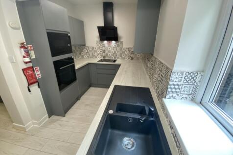 Modern kitchen featuring sleek cabinetry and st...