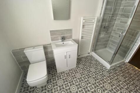 A modern bathroom featuring a stylish shower, s...