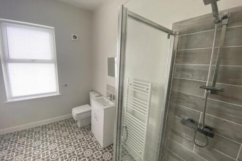 A bright and modern bathroom featuring a spacio...