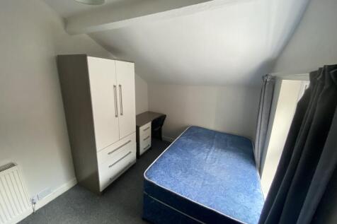 Cozy double bedroom featuring a comfortable bed...