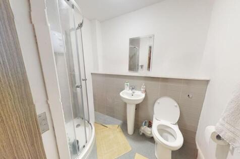 A modern bathroom featuring a sleek shower, sty...
