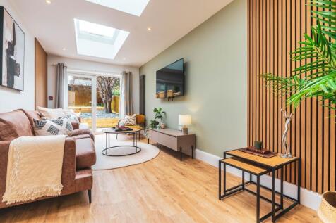 A spacious and modern living room filled with n...