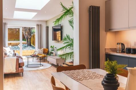 A spacious and bright modern living room with a...