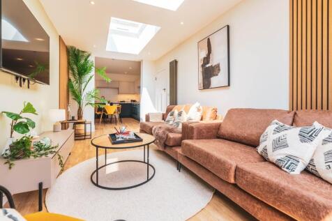A spacious and stylish modern living room featu...