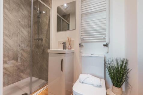 A modern and stylish bathroom with a refreshing...