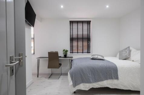 A modern double bedroom featuring a comfortable...