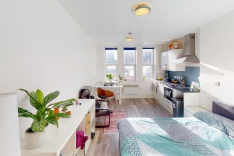 A stylish double bedroom featuring large window...