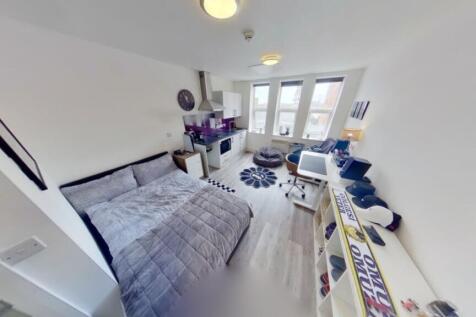 This cozy double bedroom features ample natural...