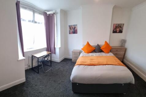 Spacious double bedroom featuring a comfortable...
