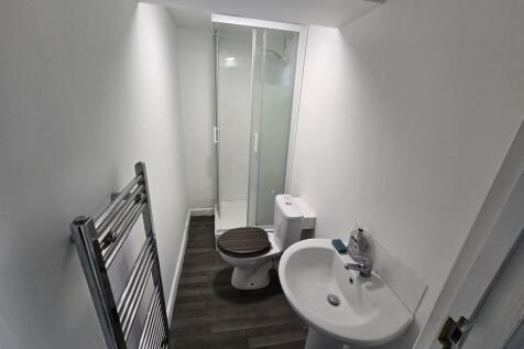 A modern bathroom featuring a sleek shower, sty...