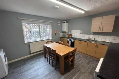 A spacious and modern kitchen with ample room f...