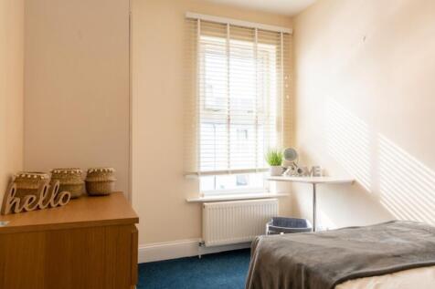 A bright and inviting double bedroom featuring ...