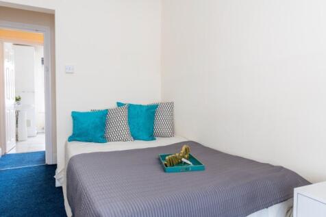 This inviting double bedroom features a cozy be...