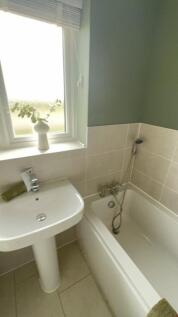 A well-maintained bathroom featuring a clean ba...