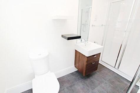 Bright, modern bathroom with a walk-in shower, ...