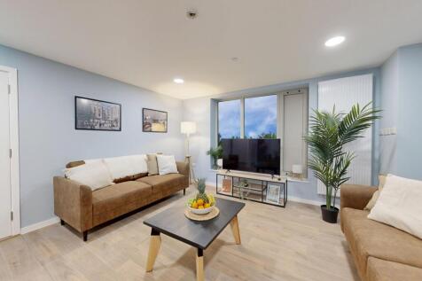 A spacious and stylish living room featuring co...
